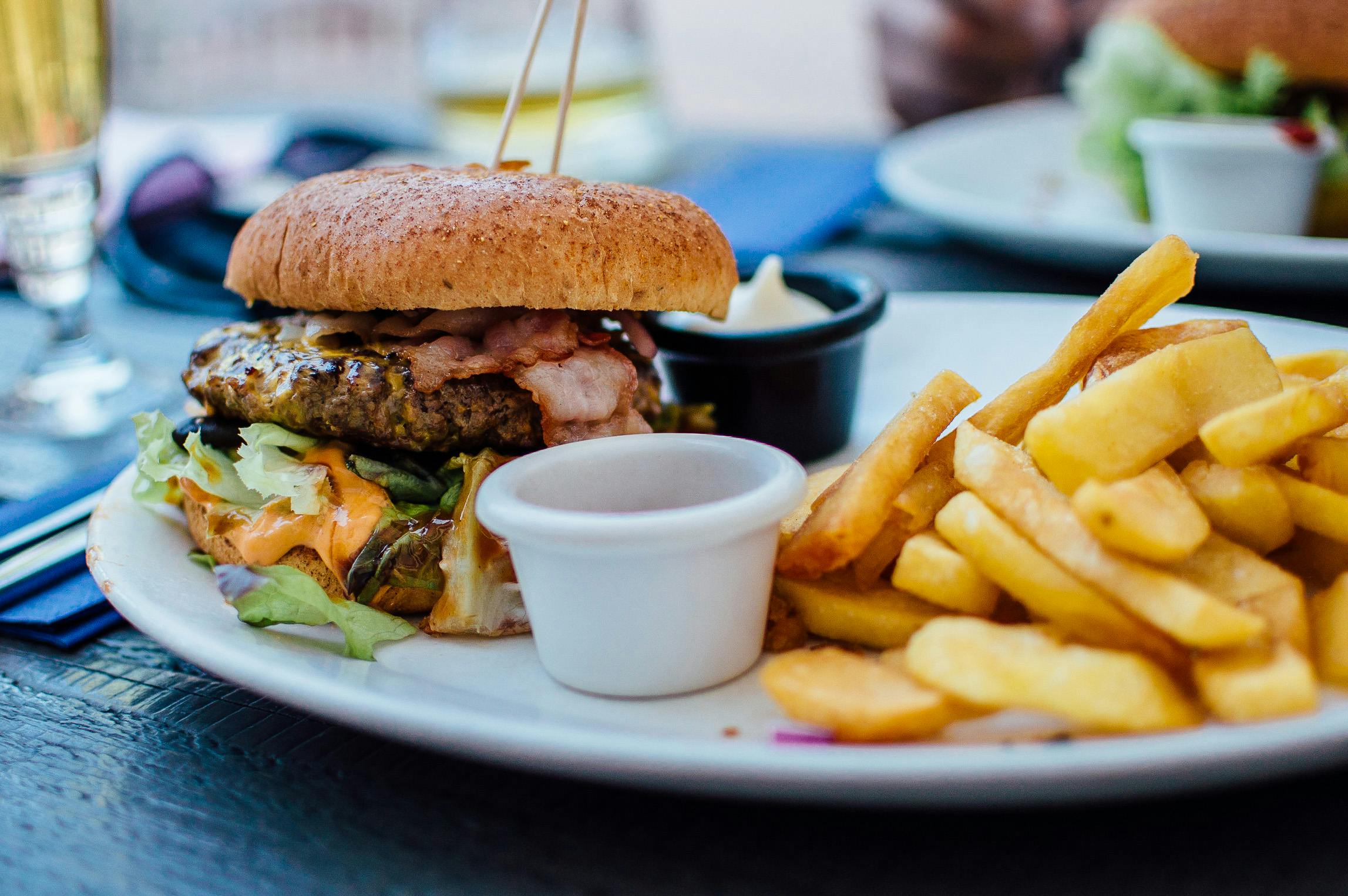 A plate with a burger and fries on it.